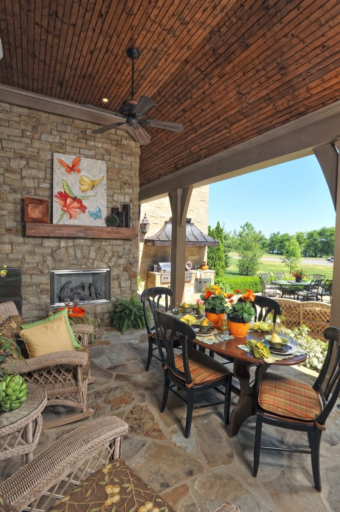 Outdoor living space with fireplace built by Hughes-Edwards Builders