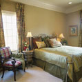 Luxury guest bedroom featuring large windows and ample space
