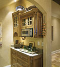 Custom kitchen bar with sink, microwave and cupboard in a Tennessee luxury home