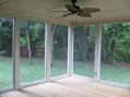 Interior photo of backyard screened porch by Hughes-Edwards Builders