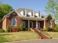 Brick home with dormers and pillars in Middle Tennessee